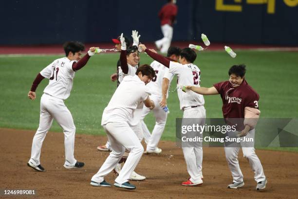 Infielder Jeon Byeong-Woo of Kiwoom Heroes celebrates with team mates after hits a game-ending double in the bottom of the ninth inning during the...