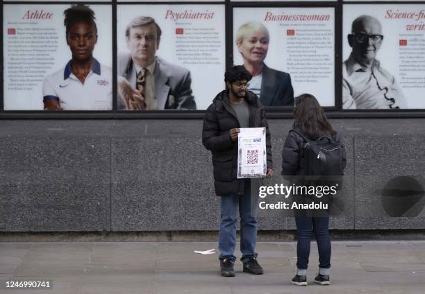Turkish students in London raise public awareness while they collect aid by carrying posters with fundraiser QR codes in London, United Kingdom on...