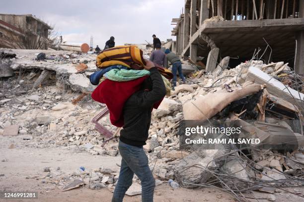 Resident salvages some blankets, as search and rescue operations continue days after a deadly earthquake hit Turkey and Syria, in the town of...