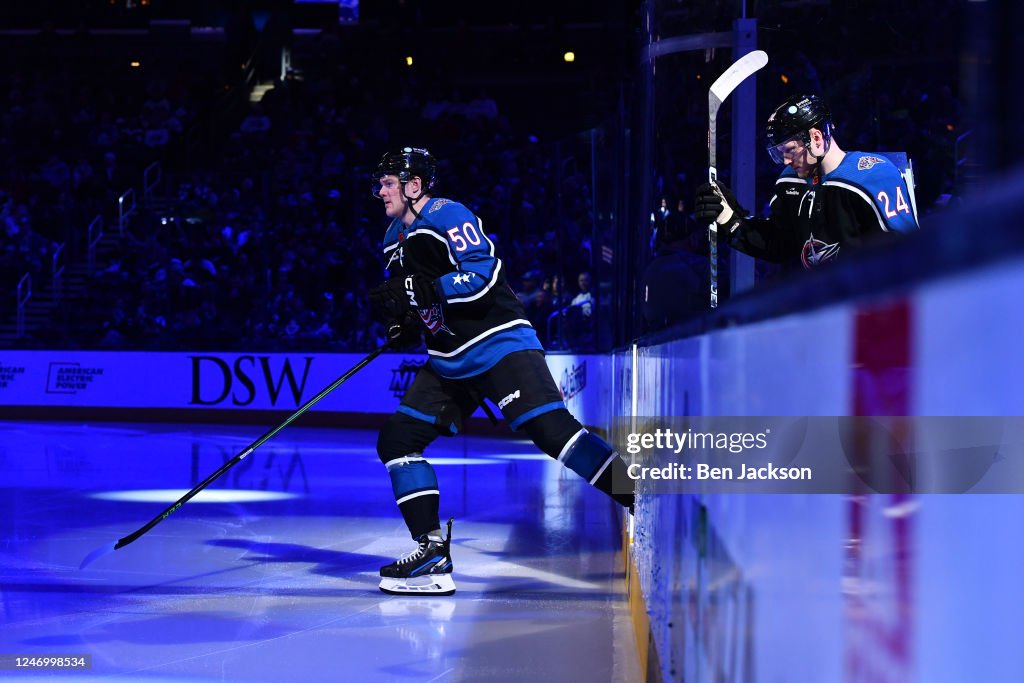 Toronto Maple Mathiue Eric Robinson and Mathieu Olivier of the Columbus Blue Jackets take ...