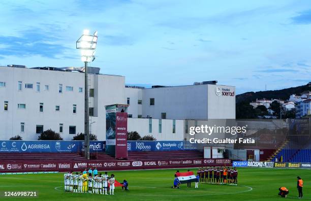 Players during a moment of silence in honor of the Turkey and Syria earthquake victims before the start of the Liga Portugal 2 match between SCU...