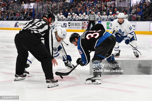 Boone Jenner of the Columbus Blue Jackets and William Nylander of the Toronto Maple Leafs battle for the puck in a face-off during the second period...