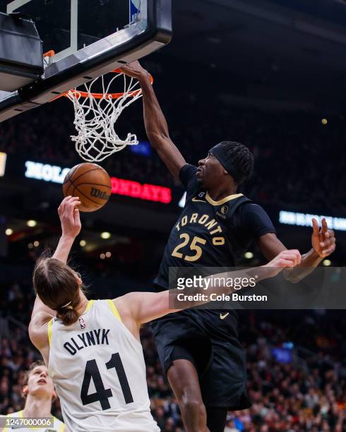 Chris Boucher of the Toronto Raptors dunks against Kelly Olynyk of the Utah Jazz during the first half of their NBA game at Scotiabank Arena on...
