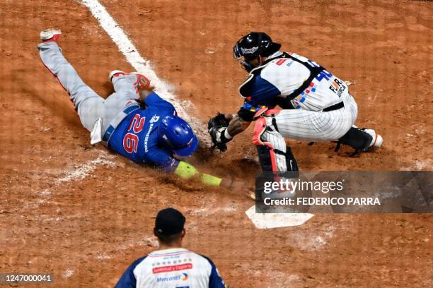 Venezuela's Leones del Caracas catcher Wilson Abraham Ramos tags out in home plate Dominican Republic's Tigres de Licey outfielder Mel Rojas Jr....