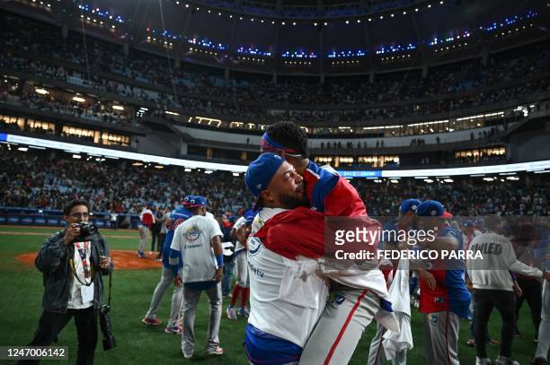Dominican Republic's Tigres de Licey players celebrate after defeating Venezuela's Leones de Caracas during their final Caribbean Series baseball...