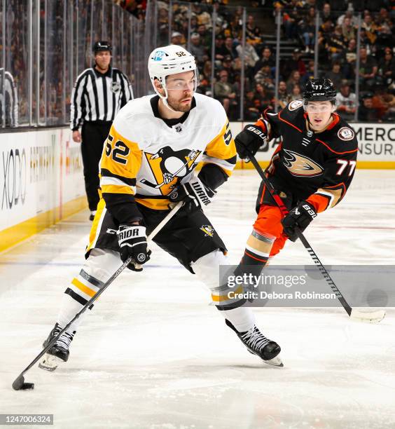 Mark Friedman of the Pittsburgh Penguins skates with the puck with pressure from Frank Vatrano of the Anaheim Ducks during the second period at Honda...