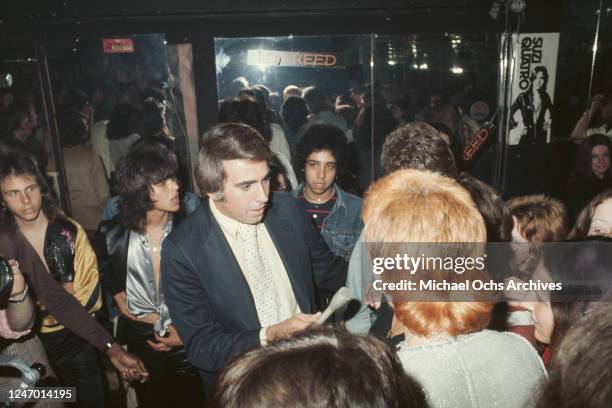 American television personality Tom Snyder interviews Chuck E Starr at Rodney Bingenheimer's English Disco in Los Angeles, USA, circa 1974.