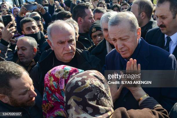 Turkish President Recep Tayyip Erdogan talks with women during his visit to the hard-hit southeastern Turkish city of Diyarbakir, five days after a...