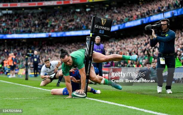 Dublin , Ireland - 11 February 2023; James Lowe of Ireland scores his side's second try despite the tackle of Damian Penaud of France during the...