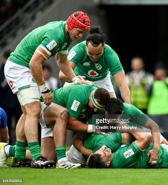 Dublin , Ireland - 11 February 2023; Hugo Keenan of Ireland, centre, celebrates with teammates Jonathan Sexton and Conor Murray after scoring his...
