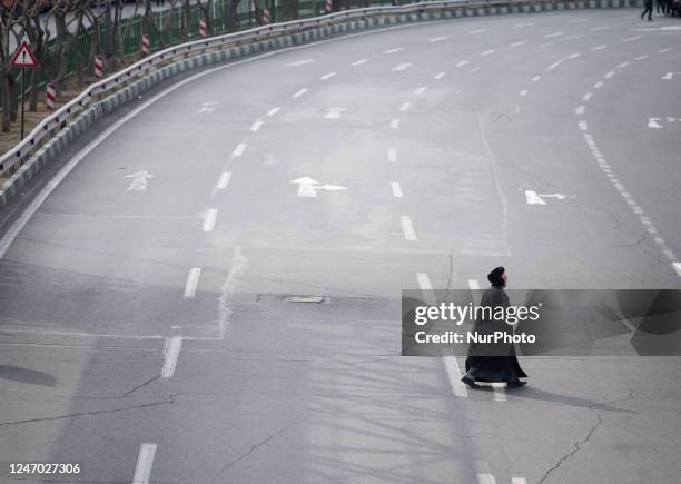 An Iranian cleric is crossing an expressway as he arrives to take part in a rally to mark the 44th anniversary of the Victory of Iran's 1979 Islamic...