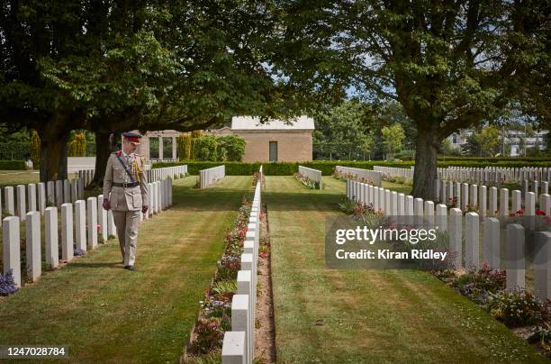 Colonel Howard Wilkinson walks amongst the graves at the Bayeux War Cemetery during commemorations for the 76th Anniversary of the D-Day landings on...