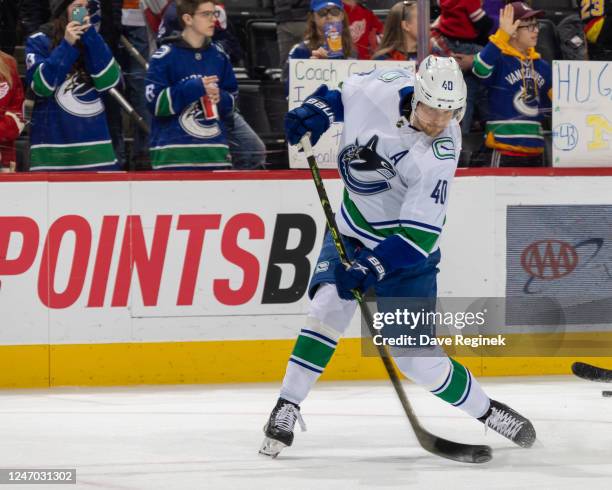 Elias Pettersson of the Vancouver Canucks shoots the puck in warm ups before an NHL game against the Detroit Red Wings at Little Caesars Arena on...