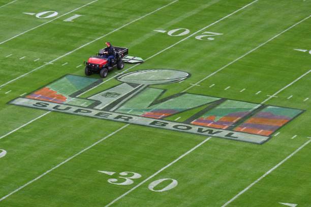 Worker prepares the field ahead of Super Bowl LVII between the Philadelphia Eagles and the Kansas City Chiefs at State Farm Stadium in Glendale,...