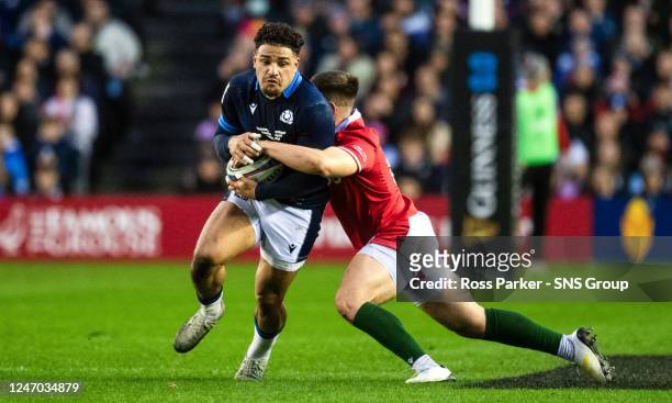 Sione Tuipulotu and Dan Biggar in action during a Guinness Six Nations match between Scotland and Wales at BT Murrayfield, on February 11 in...