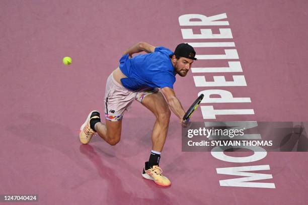 S Maxime Cressy returns the ball to Denmark's Holger Rune during their men's semi-final singles tennis match of the Open Sud de France ATP World Tour...