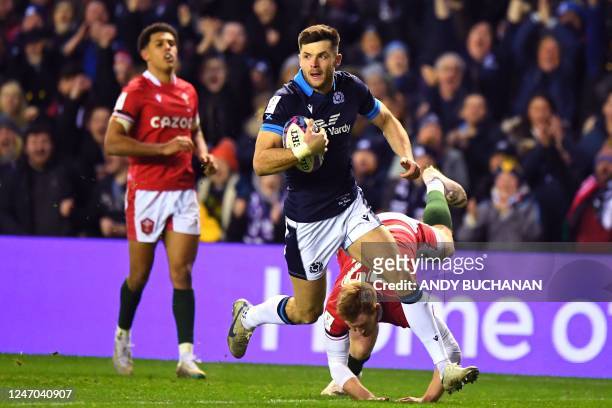 Scotland's Blair Kinghorn runs in a try during the Six Nations international rugby union match between Scotland and Wales at Murrayfield Stadium in...