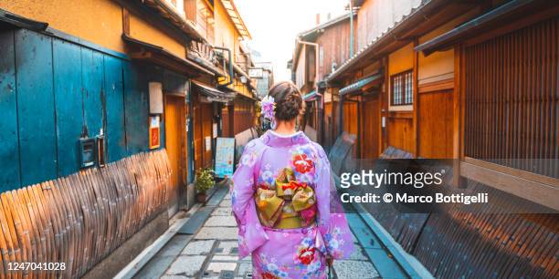one woman dressed with kimono walking in the old town of kyoto, japan - japan tourism stock pictures, royalty-free photos & images