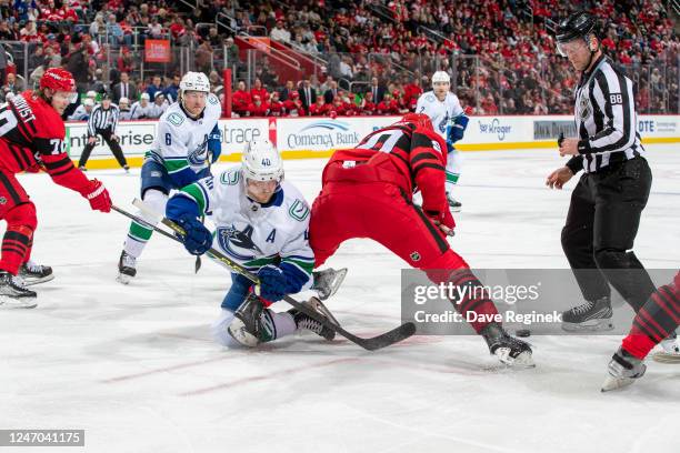 Elias Pettersson of the Vancouver Canucks faces off against Joe Veleno of the Detroit Red Wings during the second period of an NHL game at Little...