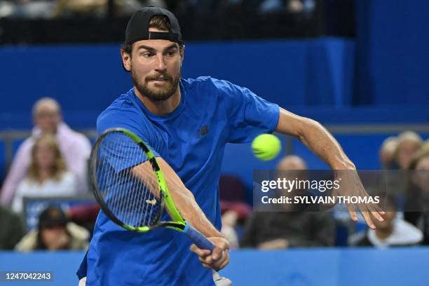 S Maxime Cressy returns the ball to Denmark's Holger Rune during their men's semi-final singles tennis match during the Open Sud de France ATP World...