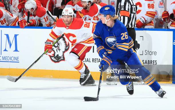 Rasmus Dahlin of the Buffalo Sabres controls the puck against Blake Coleman of the Calgary Flames during an NHL game on February 11, 2023 at KeyBank...