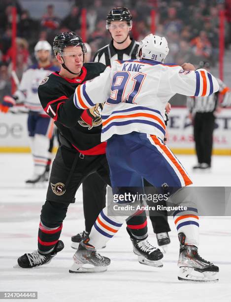 Brady Tkachuk of the Ottawa Senators fights against Evander Kane of the Edmonton Oilers at Canadian Tire Centre on February 11, 2023 in Ottawa,...