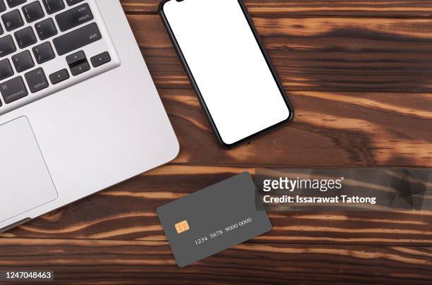 office stuff with laptop,credit card and smart phone .top view .online shopping concept. - credit card mockup stock pictures, royalty-free photos & images