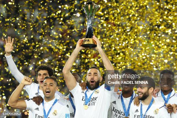 Real Madrid's French forward Karim Benzema celebrates with the trophy at the end of the FIFA Club World Cup final football match between Spain's Real...