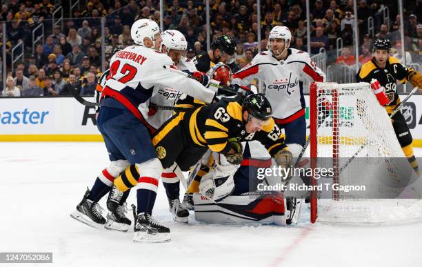 Evgeny Kuznetsov of the Washington Capitals crosschecks Brad Marchand of the Boston Bruins during the first period at the TD Garden on February 11,...