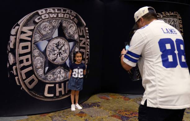 Child poses in front of an image of a Dallas Cowboys Super Bowl ring during the NFL Super Bowl Experience February 11 at the Phoenix, Arizona,...