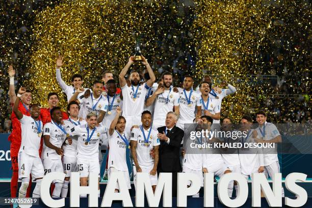 Real Madrid's players celebrate with the trophy at the end of the FIFA Club World Cup final football match between Spain's Real Madrid and Saudi...