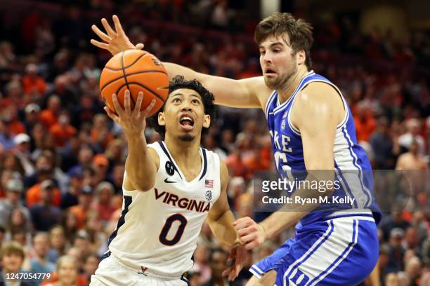 Kihei Clark of the Virginia Cavaliers shoots past Ryan Young of the Duke Blue Devils in the second half during a game at John Paul Jones Arena on...