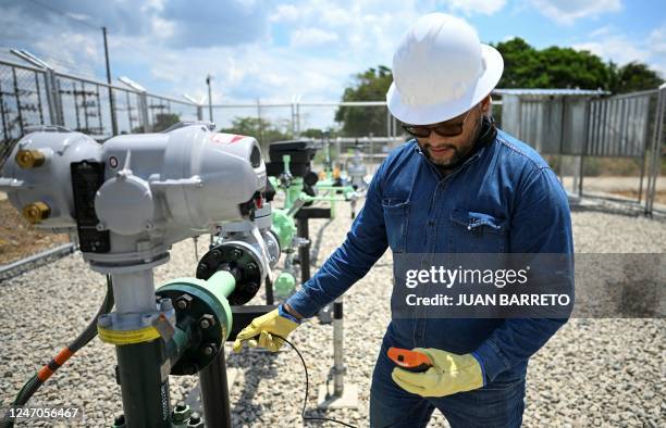 Worker fixes a pipeline at the plant of Colombian petroleum company Ecopetrol in Acacias, Meta Department, south of Bogota on February 10, 2023.