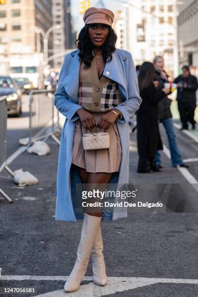 Crystal Suggs is seen wearing a sweater by Burberry, hat by Ruslan Baginsky, skirt by Amazon, boots by Schutz and a handbag by Chanel at Spring...