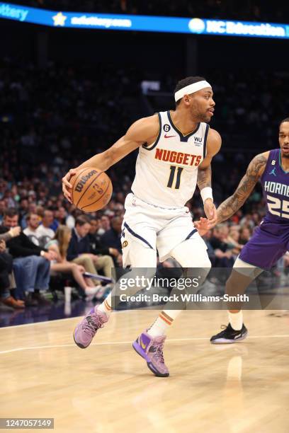 Bruce Brown of the Denver Nuggets handles the ball during the game against the Charlotte Hornets on February 11, 2023 at Spectrum Center in...