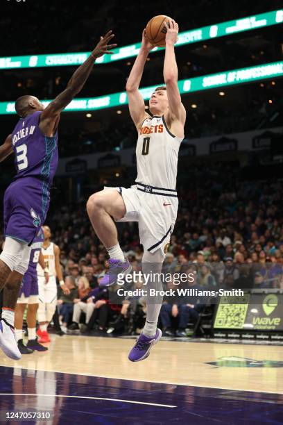 Christian Braun of the Denver Nuggets drives to the basket during the game against the Charlotte Hornets on February 11, 2023 at Spectrum Center in...