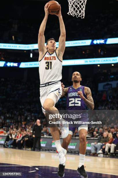 Vlatko Cancar of the Denver Nuggets drives to the basket during the game against the Charlotte Hornets on February 11, 2023 at Spectrum Center in...