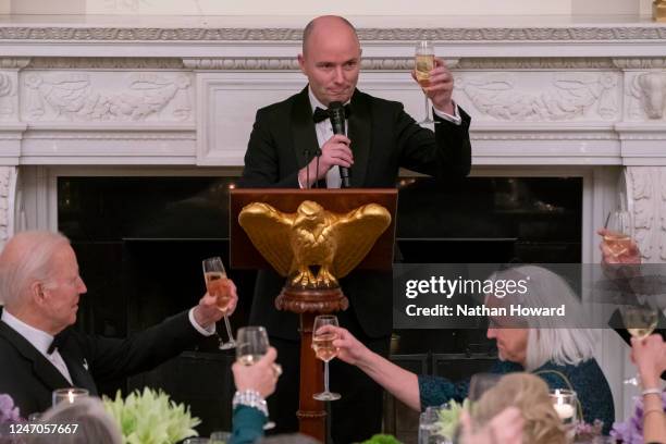 President Joe Biden listens as National Governors Association Vice Chair, Governor Spencer Cox of Utah delivers a toast during a black-tie dinner in...