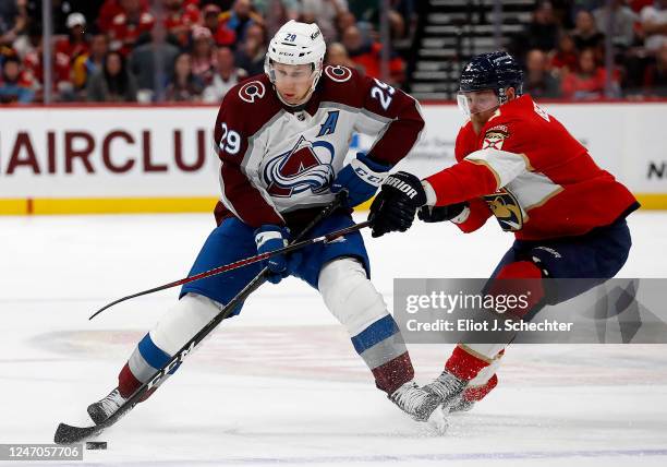 Sam Bennett of the Florida Panthers tangles with Nathan MacKinnon of the Colorado Avalanche at the FLA Live Arena on February 11, 2023 in Sunrise,...