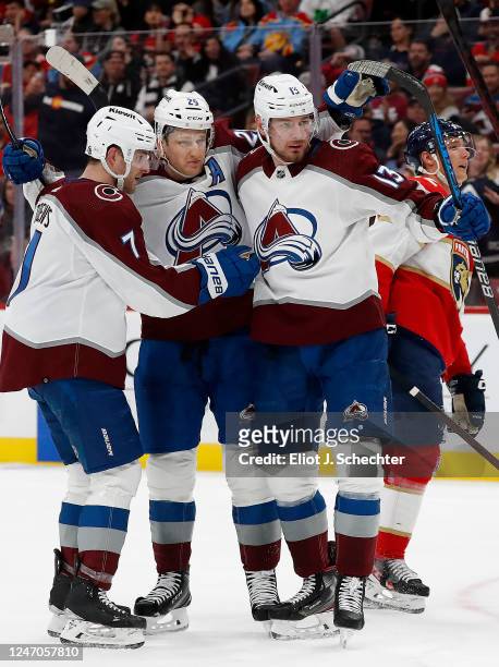 Nathan MacKinnon of the Colorado Avalanche celebrates his goal with teammates Devon Toews and Valeri Nichushkin during the second period against the...