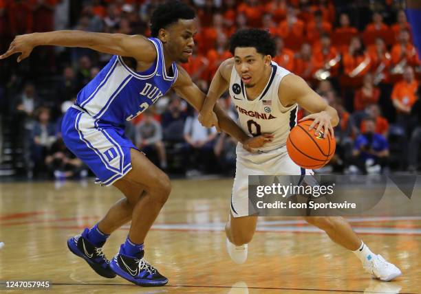 Virginia Cavaliers guard Kihei Clark dribbles the ball while attempting to elude Duke Blue Devils guard Jeremy Roach during a men's college...