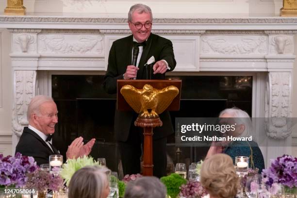 President Joe Biden listens as National Governors Association Chair, Governor Phil Murphy of New Jersey delivers a toast during a black-tie dinner in...