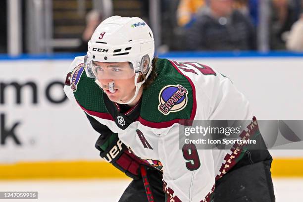 Arizona Coyotes right wing Clayton Keller chews on his mouth guard while waiting for the face off during a game between the Arizona Coyotes and the...