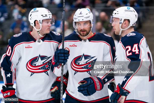 Eric Robinson of the Columbus Blue Jackets looks on with teammates Sean Kuraly and Mathieu Olivier before a faceoff against the Toronto Maple Leafs...