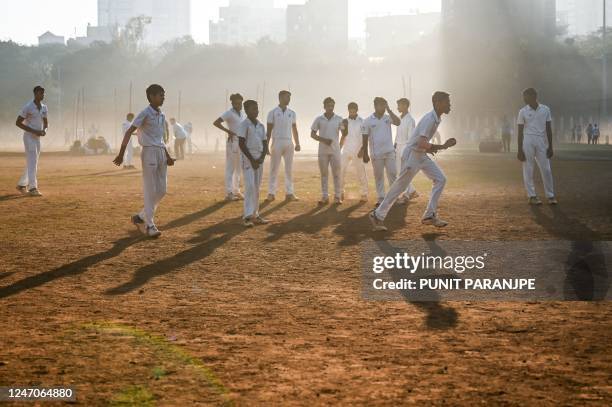 Boys take part in an early morning bowling practise session at cricket nets in Shivaji Park, a public ground in Mumbai on February 12, 2023.