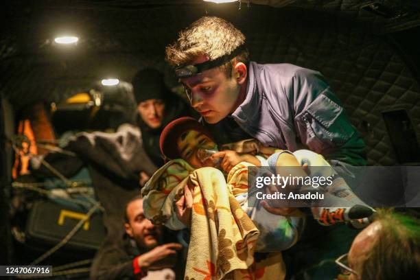 Three children, rescued from under rubble, are transferred to hospital by military helicopter after 7.7 and 7.6 magnitude earthquakes hit multiple...