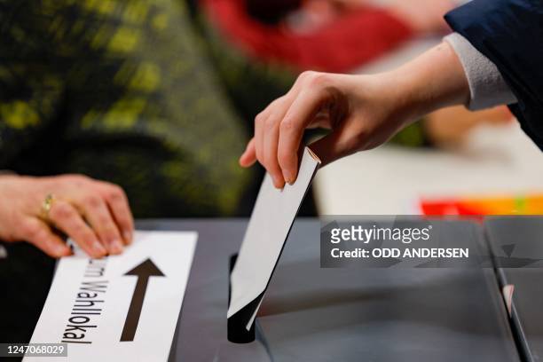 Woman casts her vote in the state's repeat elections at a polling station in west Berlin on February 12, 2023. - Berlin repeats state elections after...