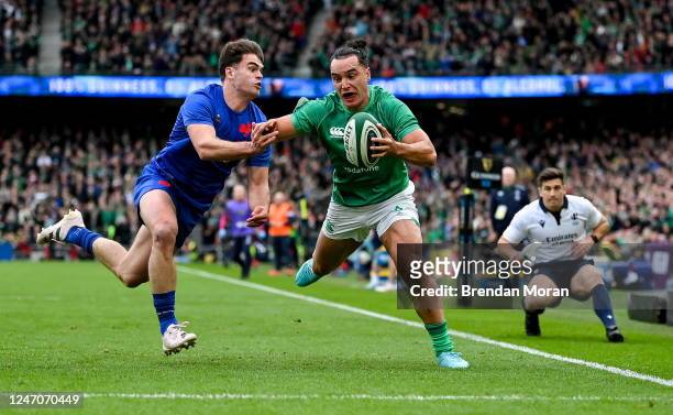 Dublin , Ireland - 11 February 2023; James Lowe of Ireland on his way to scores his side's second try despite th e tackle of Damian Penaud of France...