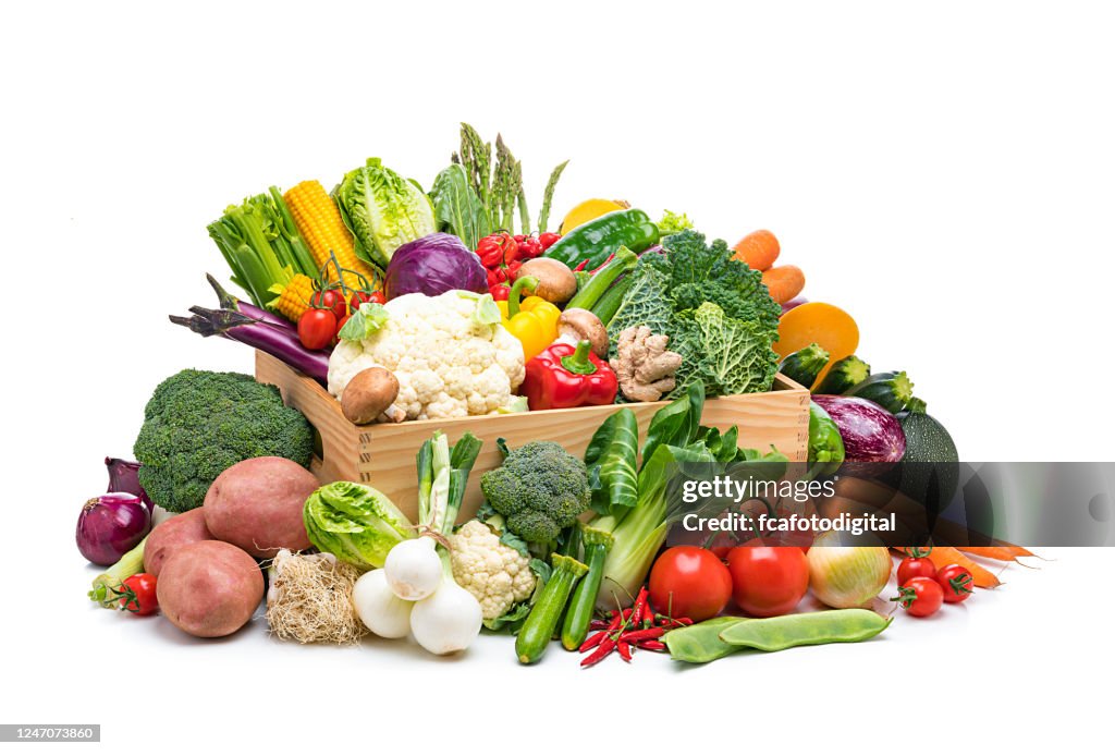 Healthy fresh organic vegetables in a crate isolated on white background