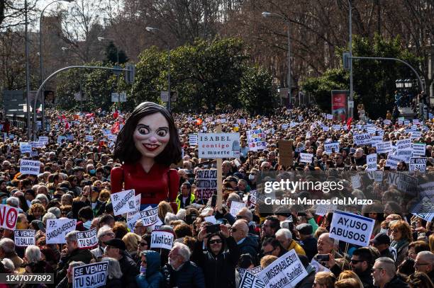 Large figure of Isabel Diaz Ayuso is seen during a demonstration in defense of the public health care system and against the policies of President of...